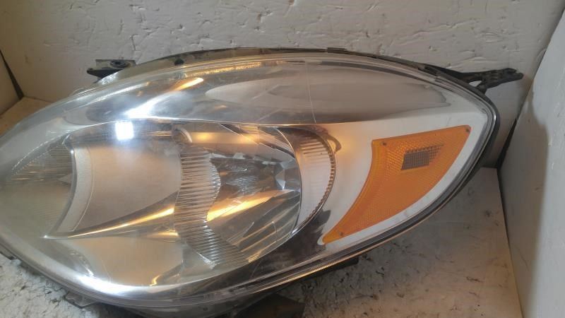 Left headlamp assembly composite used genuine OEM Nissan Versa 2012-2014