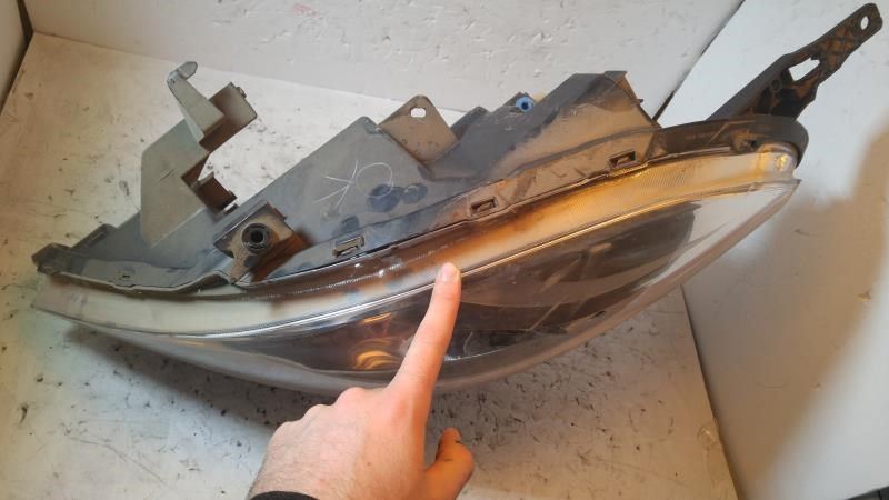 Left headlamp assembly composite used genuine OEM Nissan Versa 2012-2014