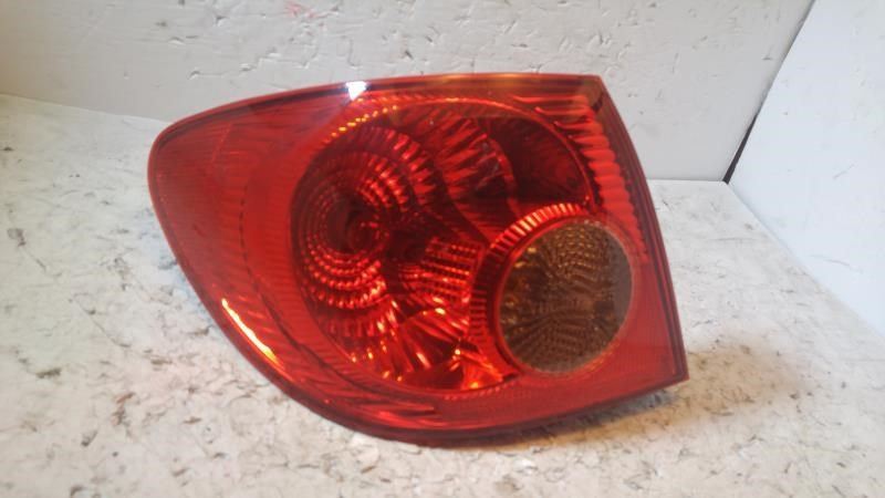 Left taillamp assembly used genuine OEM Toyota Corolla 2003-2004