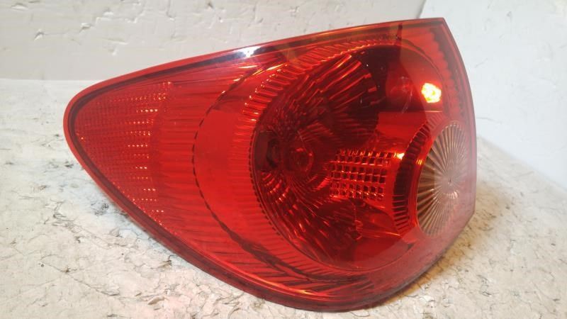 Left taillamp assembly used genuine OEM Toyota Corolla 2003-2004