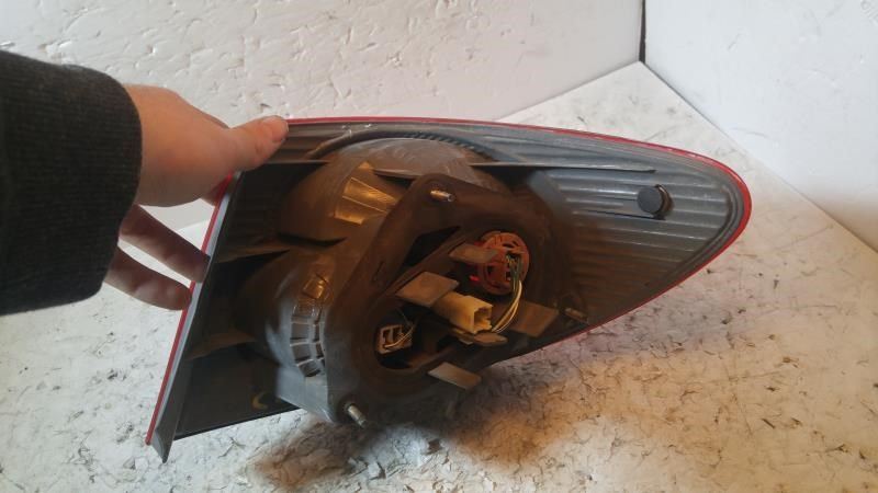 Left taillamp assembly used genuine OEM Toyota Corolla 2003-2004