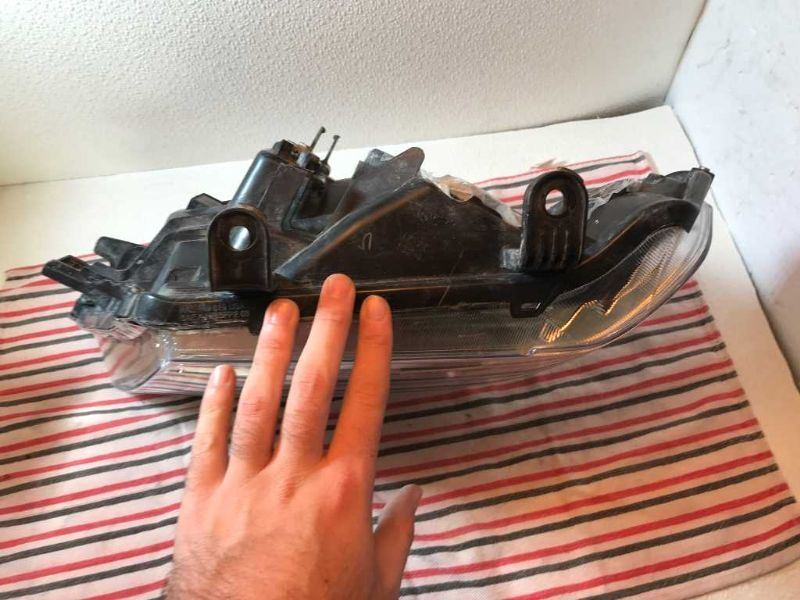 Left headlamp assembly composite used genuine OEM Nissan Frontier 2005-2008