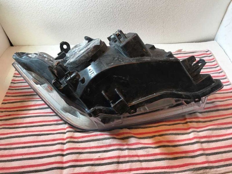 Left headlamp assembly composite used genuine OEM Nissan Frontier 2005-2008