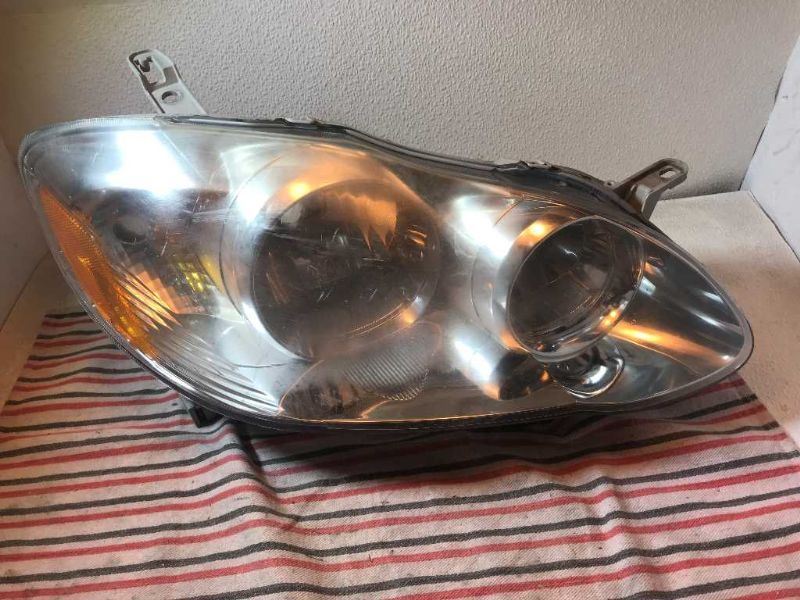 Right headlamp assembly composite used genuine OEM Toyota Corolla 2003-2004